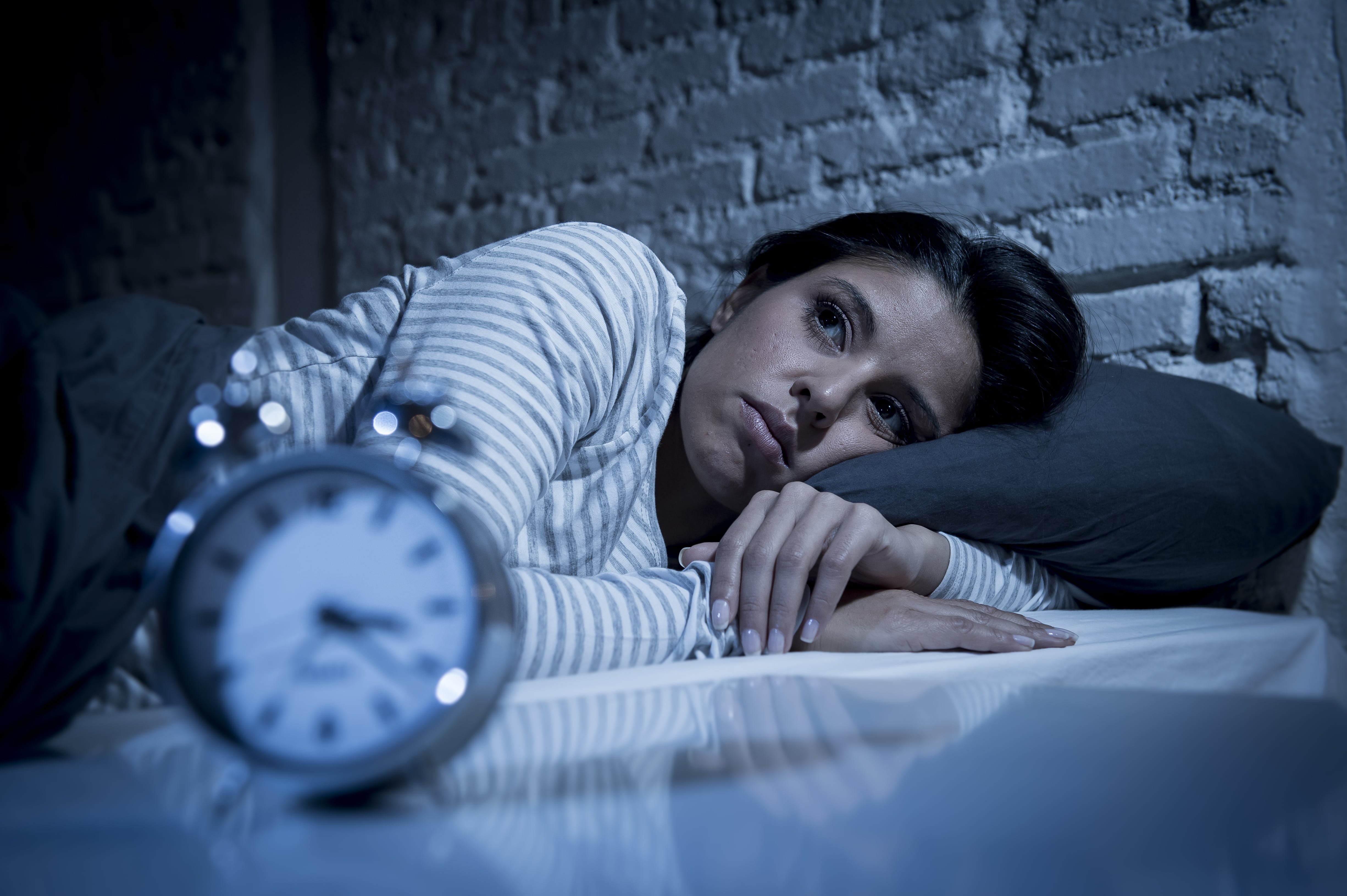 Woman with insomnia lying awake in bed