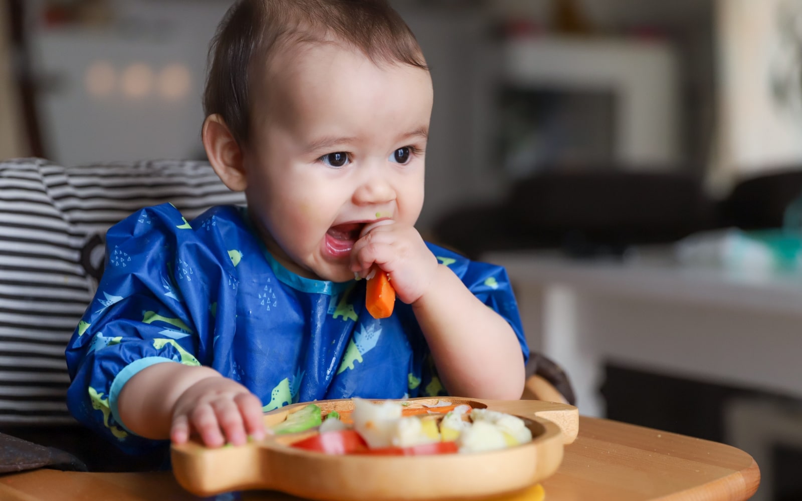 Child eating first solid foods